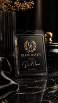 Glow Haven Dark Opium clam shell wax melt in a black and gold labelled pack on black marble